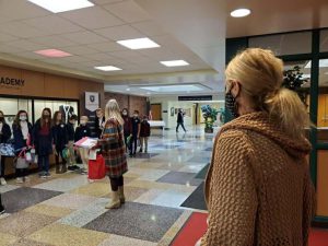 6th graders gifting Mrs. Gillon their necklace