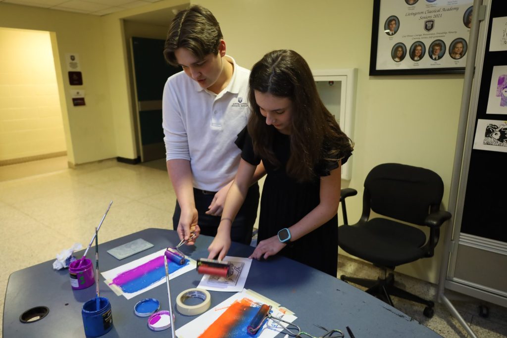 Students create vibrant artwork with paint rollers in a creative classroom environment.