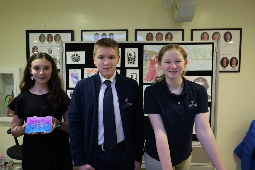 Students proudly display their creative projects in a vibrant classroom exhibition.