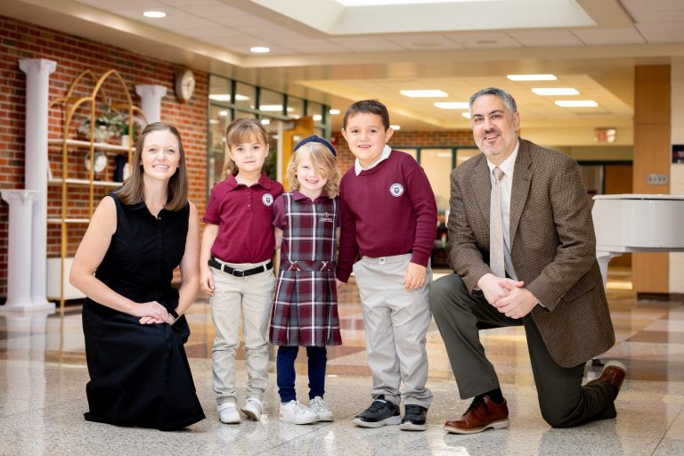 Joyful school group photo with students and staff in a lively educational environment.