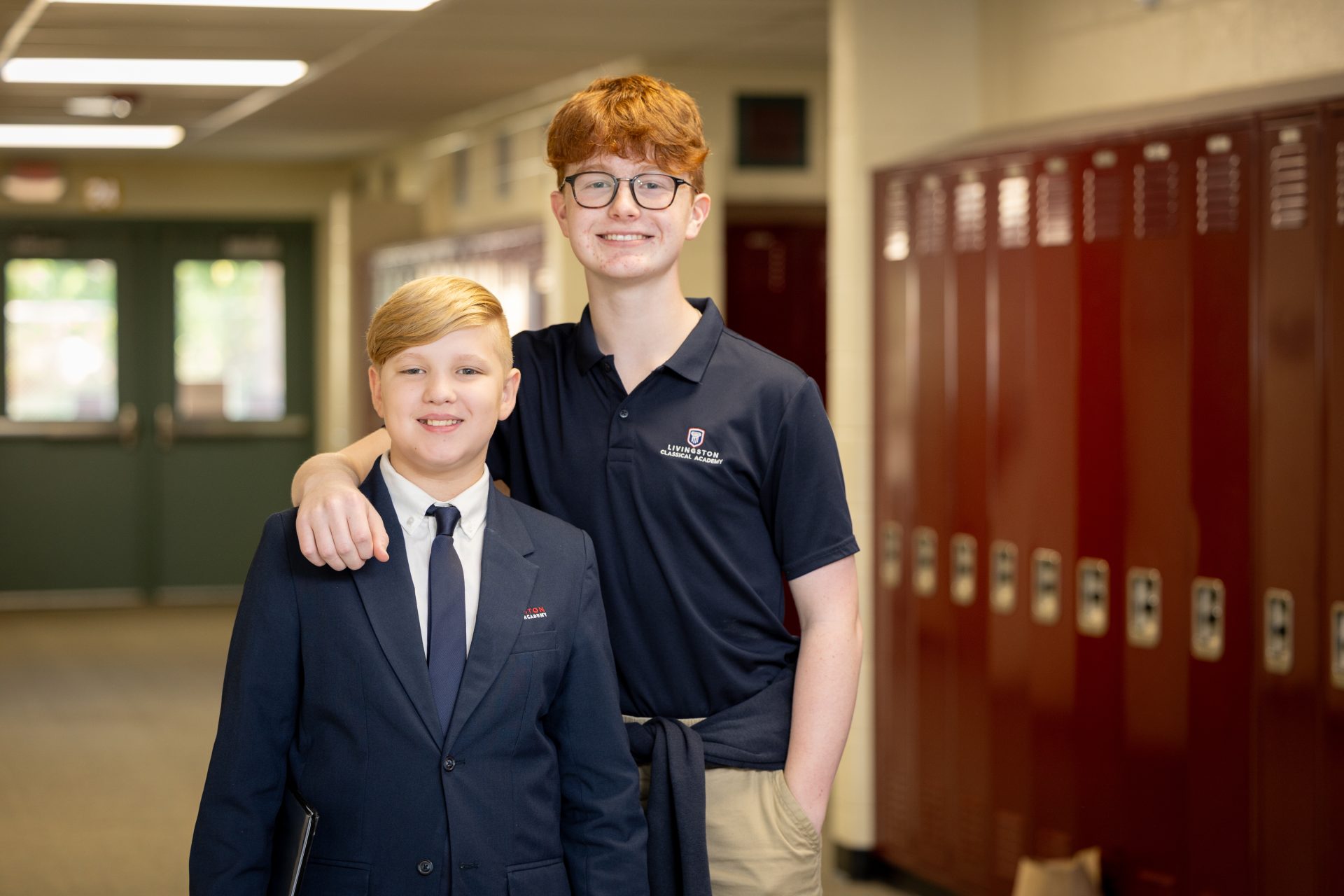Boys in school hallway show friendship, confidence, and school spirit at Livingston Classical Academy.