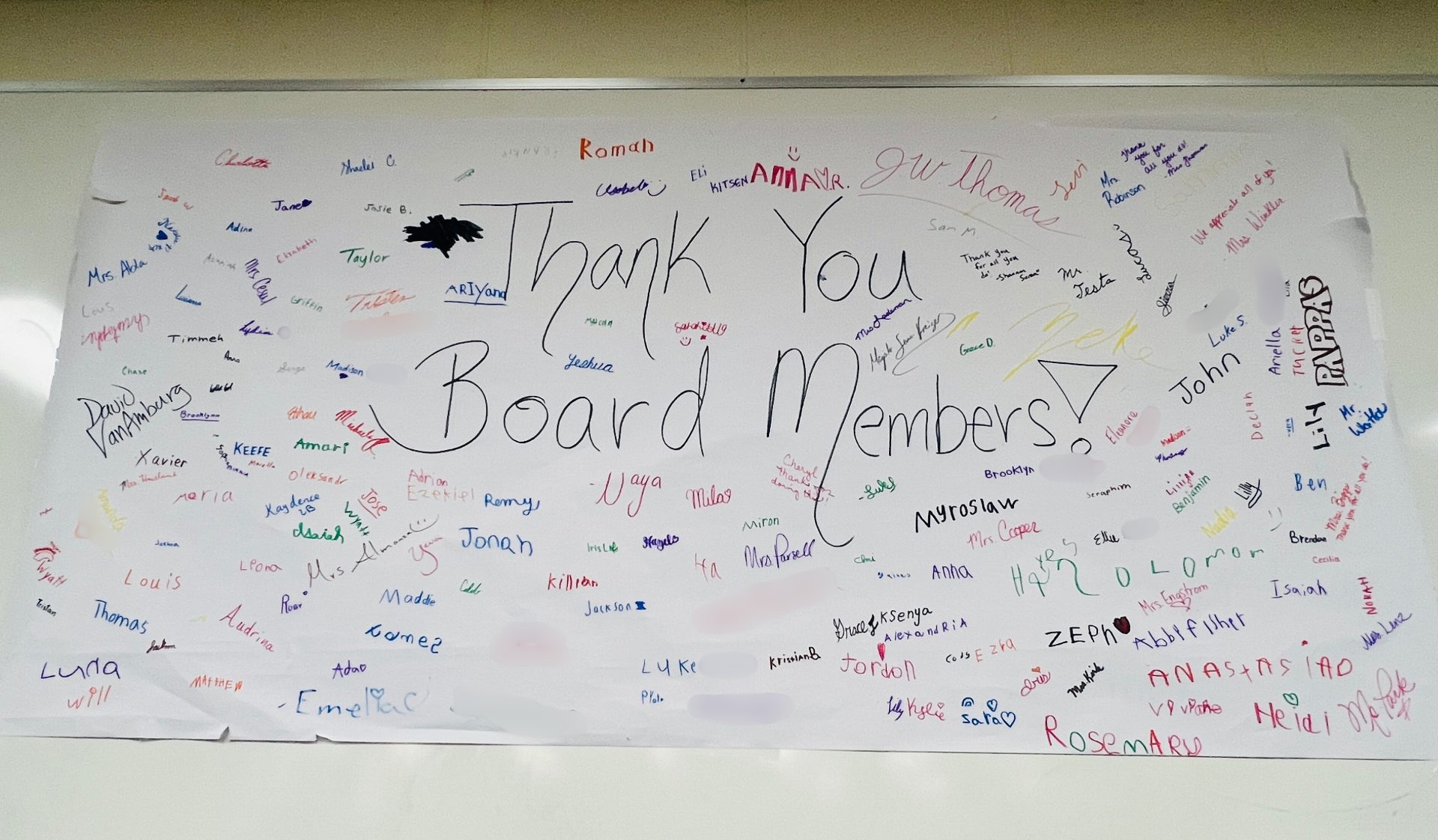 Colorful Thank You Board Members! banner filled with signatures, expressing gratitude and appreciation.